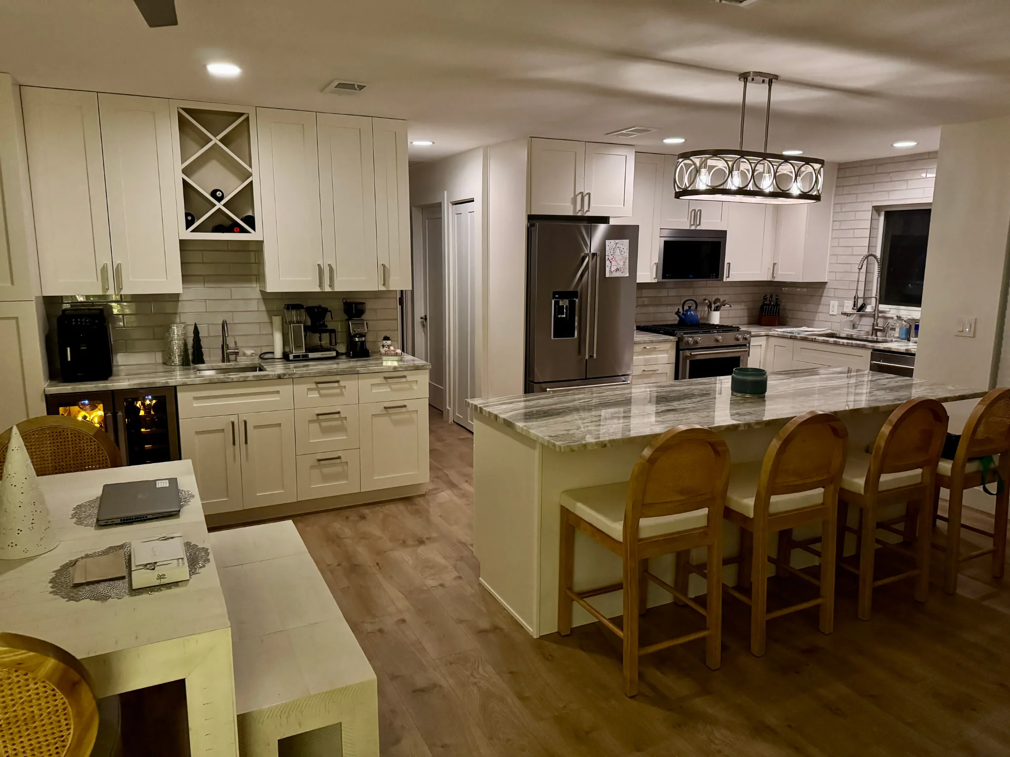 Cream shaker cabinets, quartz countertops, stainless steel appliances, island with seating